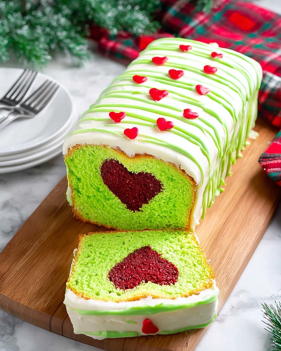 The image shows a rectangular loaf cake layered in three steps on a white marbled surface. The bottom layer is a golden brown cake with a green tint inside, with a slightly cracked top and soft texture. The middle layer is the same cake covered evenly with smooth white frosting spread thickly, creating soft waves on the surface. The top layer adds thick, bright green icing piped diagonally across the white frosting in irregular stripes, decorated with small red heart-shaped sprinkles scattered evenly. The cake sits on a white plate. Photo taken with an iphone --ar 4:5 --v 7