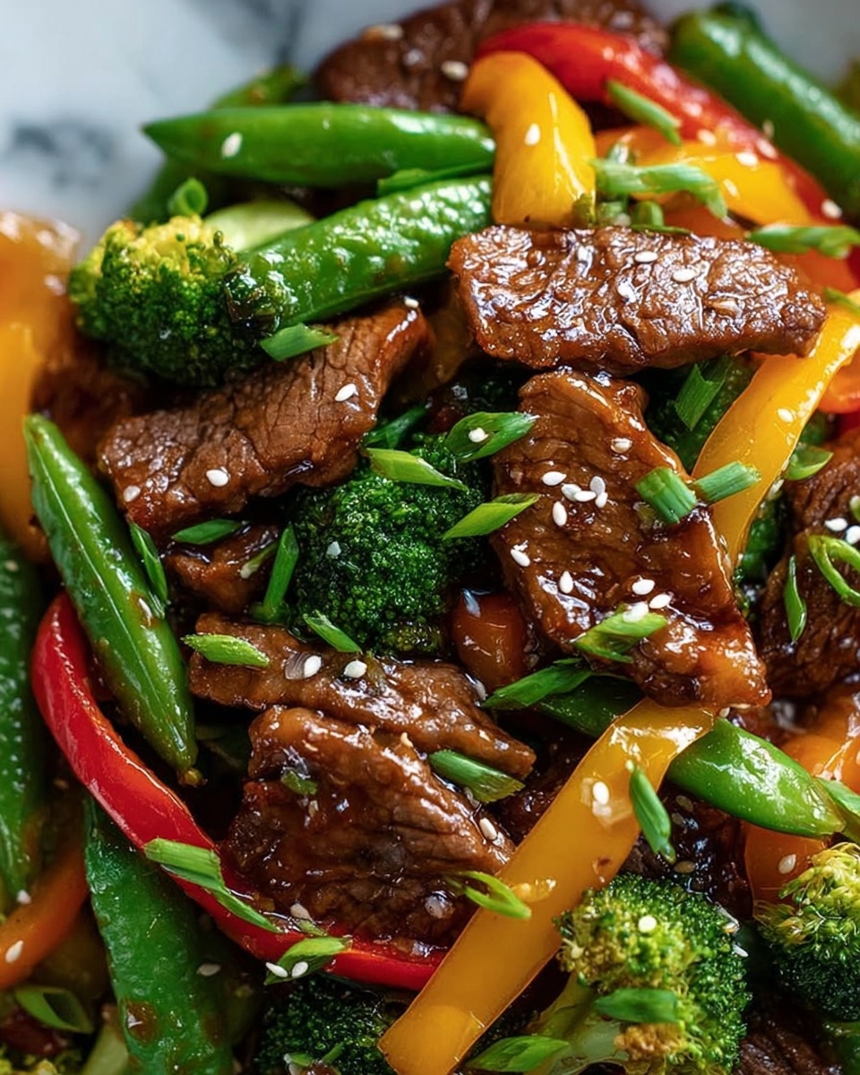 This image shows a close-up of a stir-fry dish with multiple layers of ingredients. The bottom layer includes green broccoli florets with a textured surface, bright green snap peas, and strips of red and yellow bell peppers that add color and contrast. On top, there are several brown pieces of cooked beef with a glossy finish, garnished with small chopped green onions and white sesame seeds scattered around. The food is placed closely together, making the dish look full and rich. The background is a white marbled surface. Photo taken with an iphone --ar 4:5 --v 7