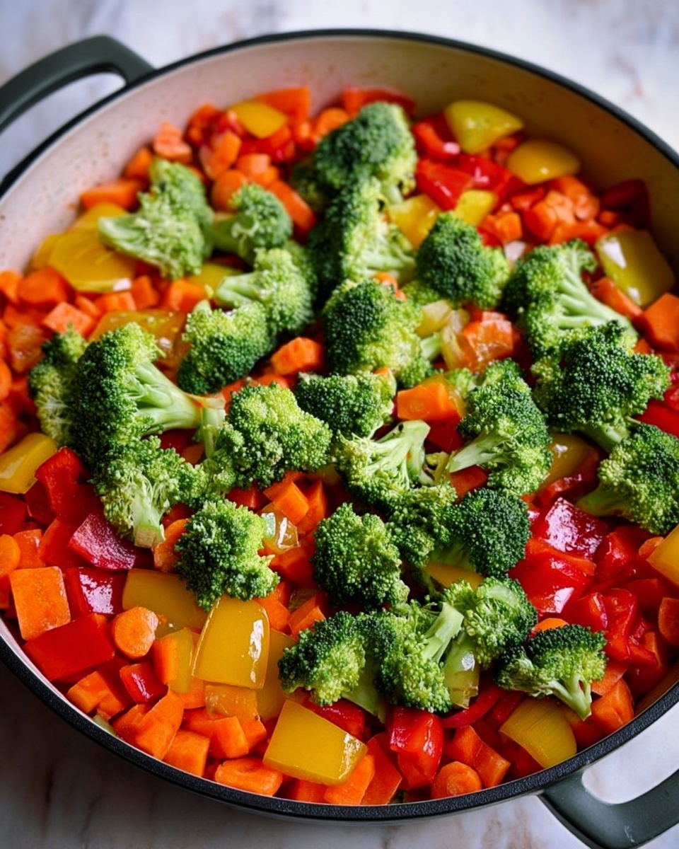 The image shows a white round pan filled with a colorful mix of vegetables. The bottom layer has uneven pieces of orange carrots, red bell peppers, and yellow bell peppers scattered. On top, there are bright green broccoli florets spread evenly over the vegetables. The pan is placed on a white marbled surface. The light highlights the fresh and slightly shiny texture of the vegetables, making them look fresh and vibrant. photo taken with an iphone --ar 4:5 --v 7