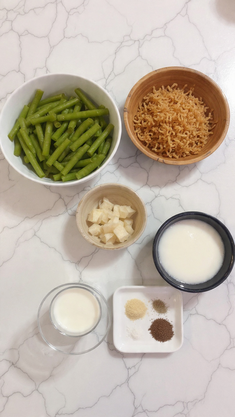 The image shows five separate dishes and bowls placed on a white marbled surface. At the top right is a white bowl filled with bright green cut green beans, smooth and evenly sized. To the left is a wooden bowl filled with golden brown crispy fried onions, showing a crunchy texture and uneven shapes. Below the green beans bowl is a smaller dark bowl filled with creamy white sauce with bits of darker brown in it, looking thick and smooth. To the right of the sauce is a clear glass filled with white milk. Below the milk is a small white dish holding seasonings in three sections: black pepper, white salt, and a light yellow powder, all finely ground and placed side by side. Photo taken with an iphone --ar 4:5 --v 7