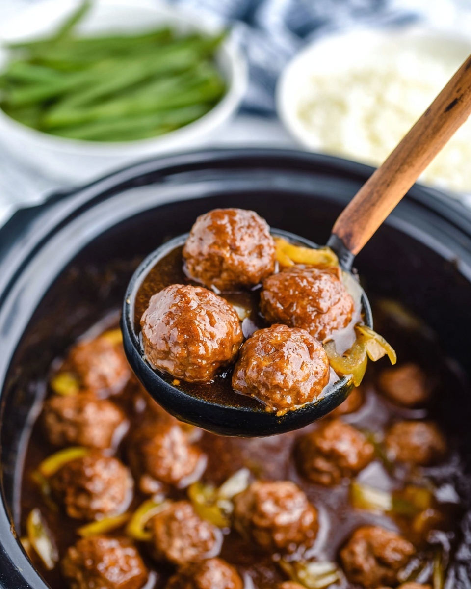 The image shows round, brown meatballs in a dark ladle held above a black pot filled with more meatballs in a brown sauce with visible bits of yellow onion. In the background, blurred white bowls contain green beans and white rice, all set on a white marbled surface. Photo taken with an iphone --ar 4:5 --v 7