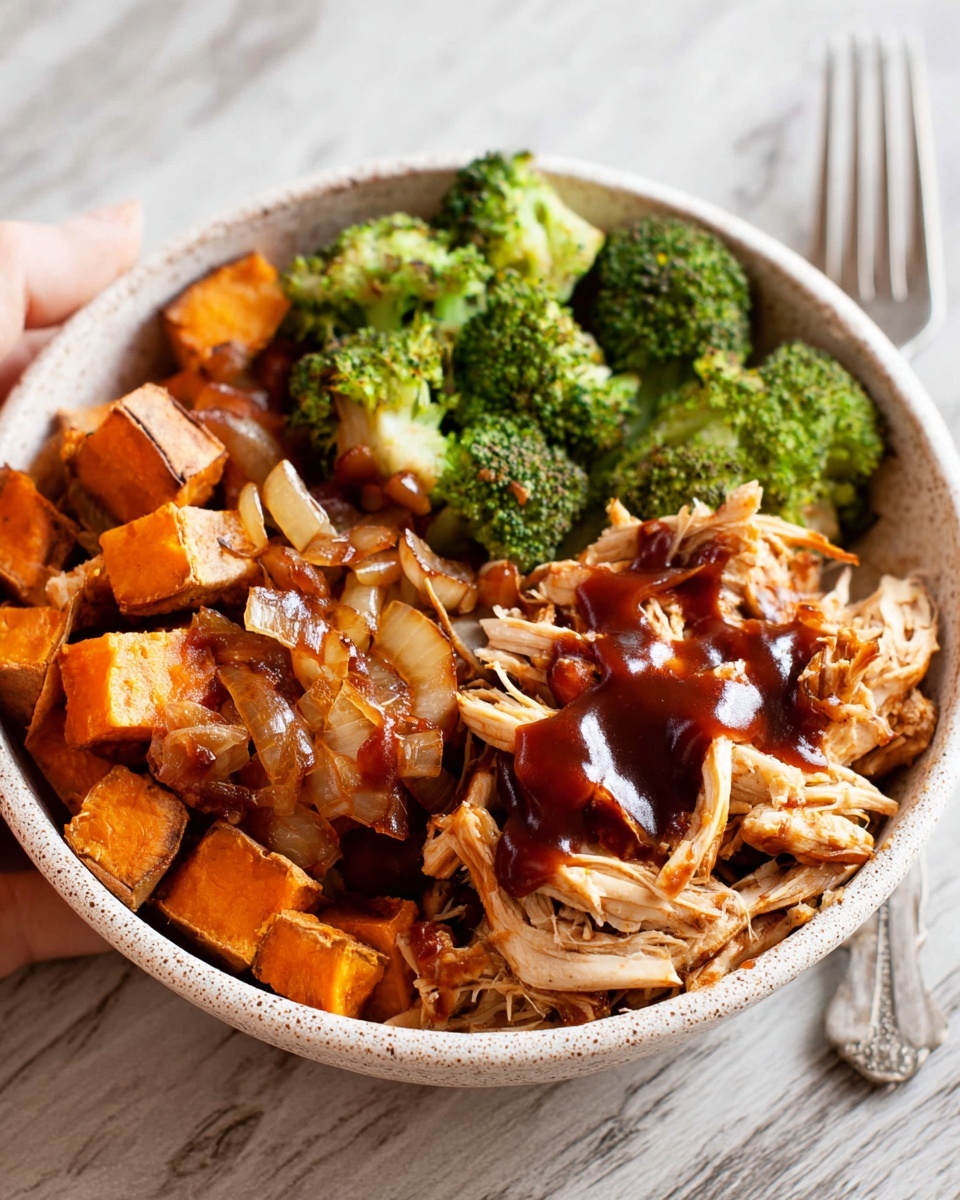 A round bowl filled with three main layers: on the right side, shredded light tan chicken drizzled with shiny dark brown barbecue sauce, in the middle back, bright green steamed broccoli florets, and on the left side, roasted cubed orange sweet potatoes mixed with browned onions. The bowl has a light speckled pattern and is placed on a white marbled surface. A silver fork is partially visible on the right side, and a woman's hand holds the bowl from the back. Photo taken with an iphone --ar 4:5 --v 7