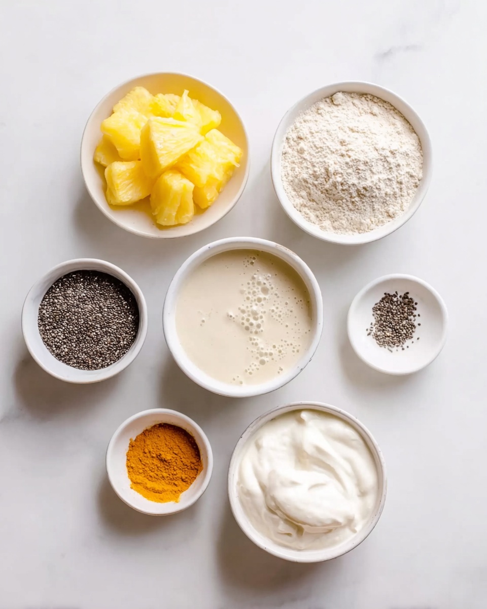 The image shows seven small white bowls arranged on a white marbled surface, each holding different ingredients. From top left, the first bowl contains bright yellow pineapple chunks with a frosty texture, the second bowl holds fine light beige flour, and to the right is a bowl filled with light cream-colored liquid with bubbles on the surface. Below these, a bowl of black chia seeds with a slightly coarse texture is positioned to the left, next to a small bowl with fine black pepper. Below these, there is a small bowl filled with bright orange powder, likely a spice, and at the bottom right, a bowl of thick white creamy yogurt with a smooth texture. The setup is clean and bright, with each bowl clearly showing the color and texture of its ingredient. photo taken with an iphone --ar 4:5 --v 7