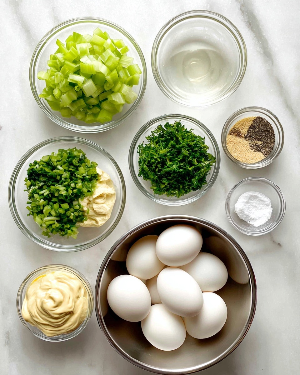 The image shows a top view of eight ingredients arranged on a white marbled surface. In the bottom right, a shiny metal bowl holds six whole white eggs with smooth shells. Around it, clear glass bowls contain chopped green celery pieces on the left, finely chopped green onions at the top center, finely chopped fresh green herbs below the green onions, creamy pale yellow mayonnaise on the bottom left, beige yellow mustard at the top right, small coarse black pepper granules next to the mustard on the right, and a few white salt crystals in a small bowl between the celery and green onions. There is also a small bowl of clear liquid placed above the mayonnaise. All ingredients are neatly placed with bright natural light enhancing their fresh colors. Photo taken with an iphone --ar 4:5 --v 7