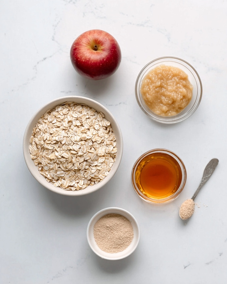 A white bowl filled with light beige oats sits in the middle on a white marbled surface. Above and to the left of the bowl is a small red apple with smooth skin. To the right of the bowl is a clear glass bowl containing a pale yellow, slightly thick sauce or spread. Above and to the right of that bowl is another clear glass bowl filled with a light brown creamy substance. Below the oats bowl, slightly to the left, is a small white bowl filled with golden amber liquid. A small spoon with a pale brown powder rests near the top right. The arrangement is neat and simple, with items spaced evenly. Photo taken with an iphone --ar 4:5 --v 7