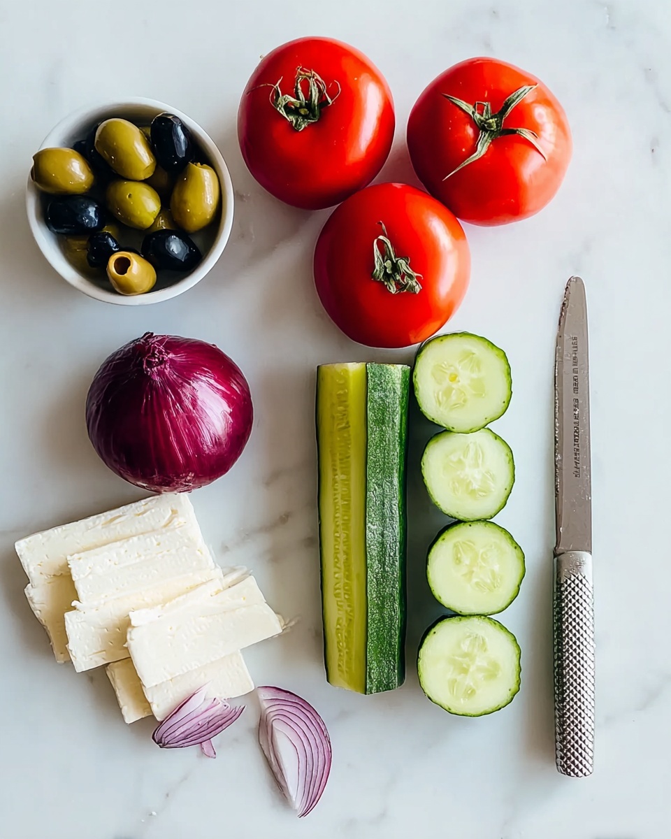 The image shows a white marbled surface with fresh ingredients neatly placed. There are four whole red tomatoes at the top right. Below the tomatoes, there are four cucumber halves with a green outer skin and pale green seeds inside, arranged vertically. To the left of the cucumbers, there are three white round slices of cheese. Next to the cheese, there is a cut red onion with deep purple layers visible, one half laying flat and the other standing on its side with some red onion skin nearby. In the top left corner, a small white bowl holds black and green olives. A shiny metal knife with a textured handle rests on the right side of the image. photo taken with an iphone --ar 4:5 --v 7