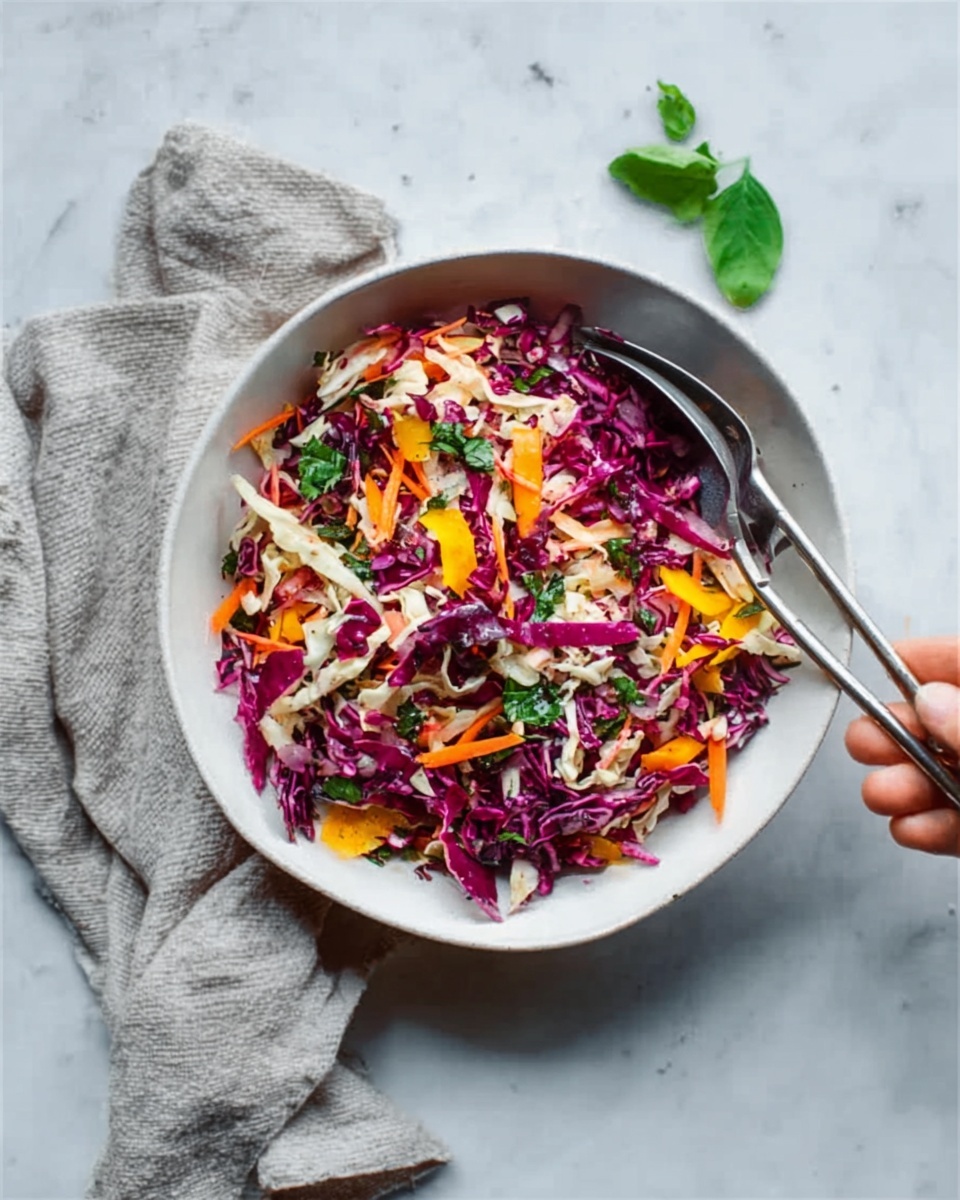 A white bowl filled with a colorful salad sits on a white marbled surface. The salad has several layers: the bottom shows bright red-purple cabbage pieces with a crisp texture. On top, there are thin strips of orange carrots and green herbs sprinkled all over, adding freshness. Shreds of light beige cabbage or similar vegetables are mixed evenly throughout the salad. A woman's hand is gently holding a pair of silver scissors near the bowl. A light gray cloth napkin is placed nearby, and a small green herb leaf sits on the surface close to the bowl. photo taken with an iphone --ar 4:5 --v 7