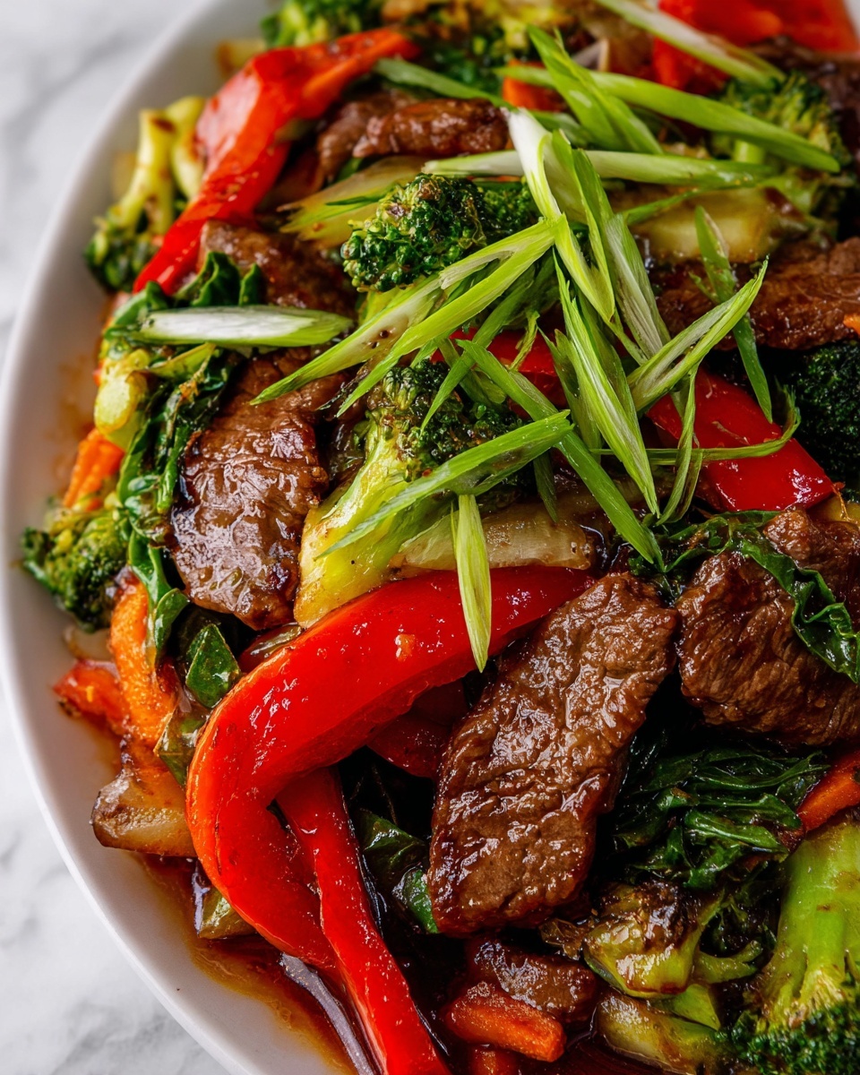 Flank Steak Stir Fry with Orange-Ginger Sauce Recipe 5 This image shows a close-up of a stir-fry dish with four main layers. The bottom layer is a light, glossy sauce covering the vegetables and meat. On top of this sauce, there are cooked vegetables including bright green broccoli florets, dark green leafy greens, vibrant orange carrot slices, and long red bell pepper strips. The third layer consists of medium brown cooked beef pieces with a shiny texture that shows they are well-cooked and tender. The top layer has thin, fresh green onion slices scattered over the dish, adding a fresh look. The dish is placed on a white plate, and the background is a white marbled surface. photo taken with an iphone --ar 4:5 --v 7
