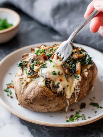 Cheesy Vegetarian Loaded Baked Potatoes with Spinach and Mushrooms Recipe