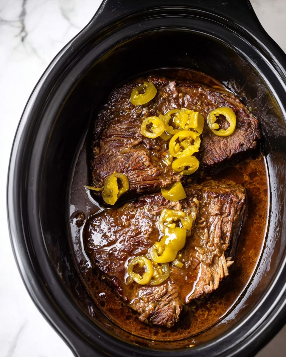The image shows two large browned pieces of meat placed inside a black slow cooker, partially covered with a rich, dark brown sauce. Thin slices of yellow-green peppers are scattered on top of the meat, adding contrast with their lighter color and slightly wrinkled texture. The slow cooker is set against a white marbled surface, and the meat looks tender with a glossy finish from the sauce. Photo taken with an iphone --ar 4:5 --v 7