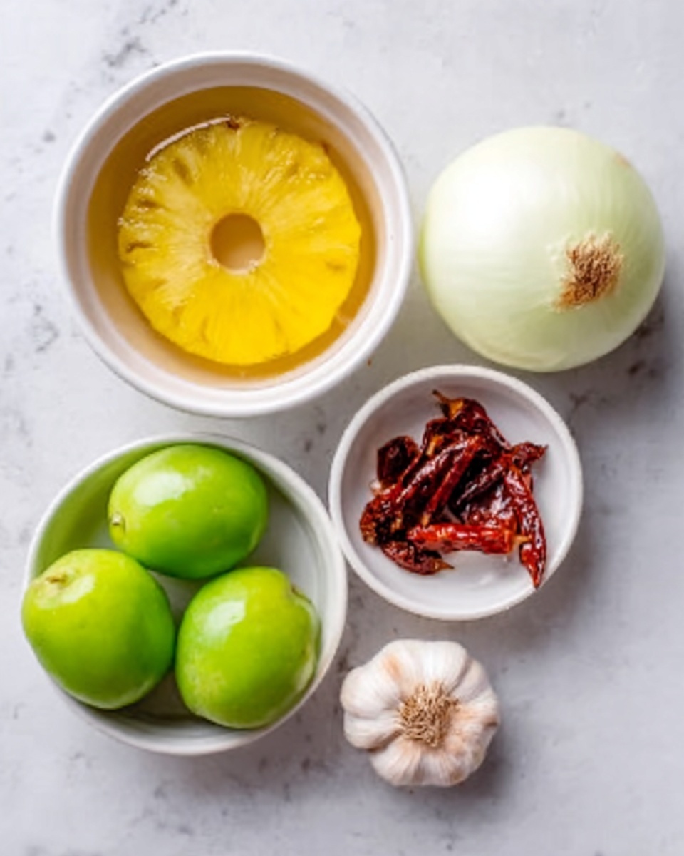 The image shows five ingredients placed on a white marbled surface. At the top left, there is a white bowl holding a bright yellow pineapple ring covered in clear liquid. To the right, a whole onion with pale skin and visible root end sits on the surface. Below the pineapple, a white bowl contains four green tomatillos with their smooth shiny skin. Next to the tomatillos, a small white dish holds dried red chilies. Between the onion and chilies, a small whole garlic bulb with light skin is placed. The scene is brightly lit and neatly arranged with a clean look. Photo taken with an iphone --ar 4:5 --v 7