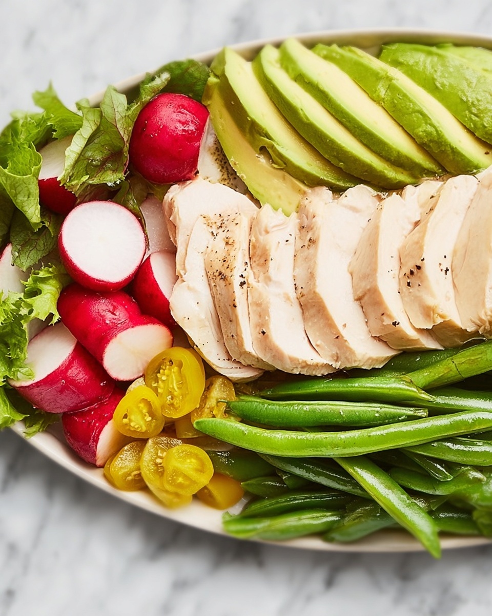 The image shows a white plate with five main layers of food arranged neatly side by side. On the right, there is a row of whole green beans with a shiny texture. Next to the green beans, there are several slices of light beige chicken with a smooth surface and some pepper seasoning. To the left of the chicken, there are thick slices of soft green avocado, fanned out slightly. Next to the avocado, there are cut radishes with bright red skin and white inside, mixed with small yellow pickled peppers. On the far left edge, there are fresh green leaves, possibly lettuce, adding a leafy texture. The entire plate rests on a white marbled surface. photo taken with an iphone --ar 4:5 --v 7