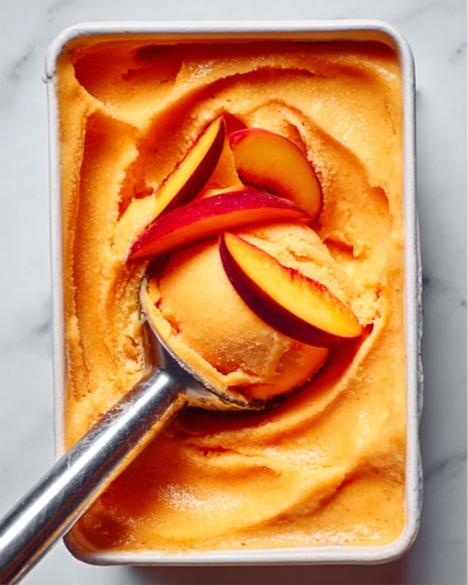 The image shows a rectangular white dish filled with a smooth, creamy orange spread. The surface has swirls made by a metal spoon that is partially inside the dish, with the spoon's handle resting on the edge. The spread looks thick and soft with small red specks scattered throughout. The dish sits on a white marbled surface with a striped cloth next to it suggesting a cozy setting. photo taken with an iphone --ar 4:5 --v 7