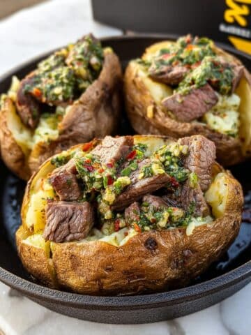 Grilled Steak Bite Loaded Baked Potatoes with Garlic Herb Butter Recipe