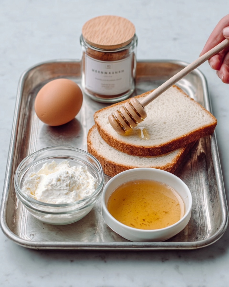 The image shows a silver metal tray on a white marbled surface. On the tray, there is a brown egg in a small round glass bowl to the left. Next to it, there is a small white bowl filled with thick white cream. A clear square jar of cinnamon with a wooden lid is placed behind the cream and egg. To the right side, two white slices of bread rest flat on the tray. In front of the bread, there is a small white bowl filled with golden honey, with a wooden honey dipper placed inside. A woman's hand holds the honey dipper above the bowl. Photo taken with an iphone --ar 4:5 --v 7