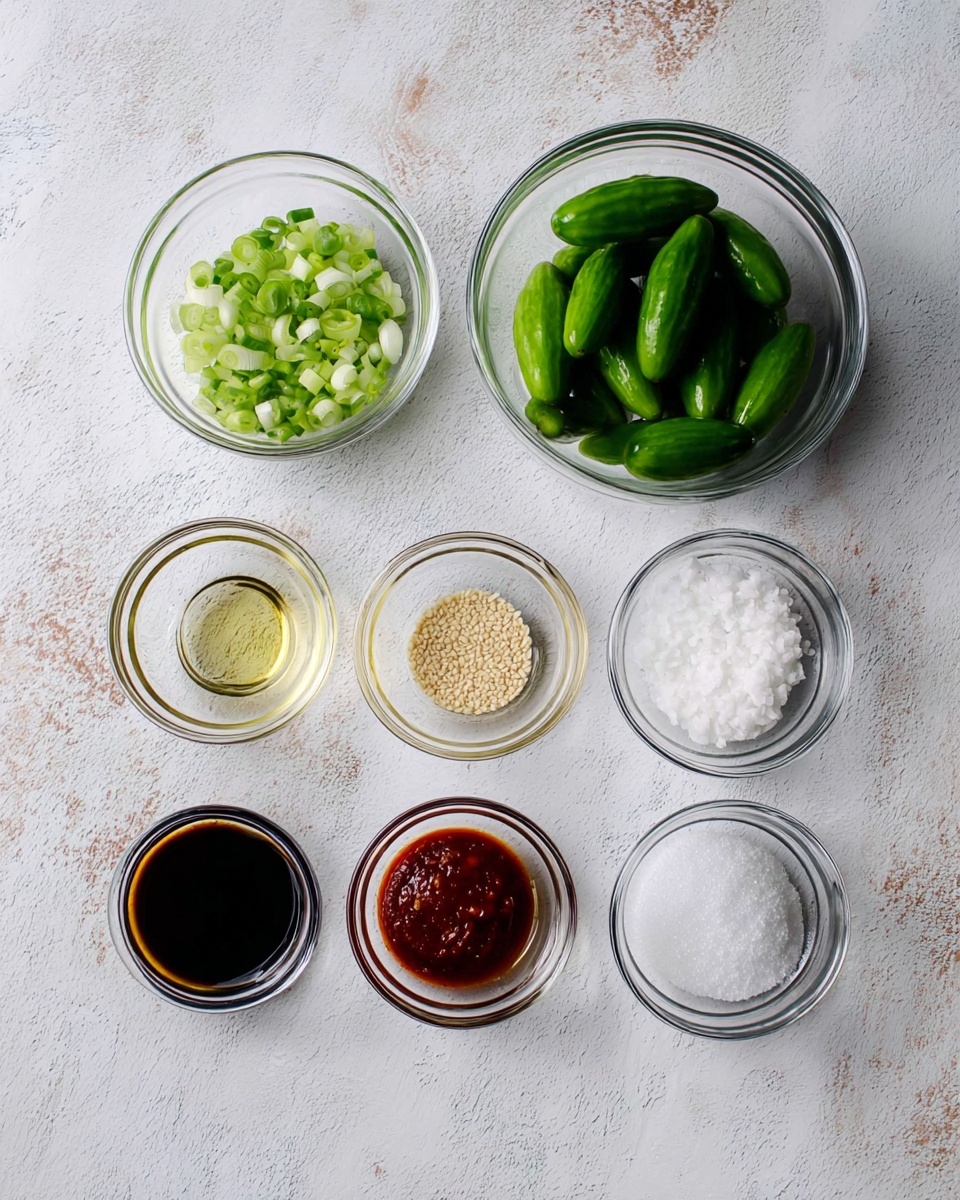 The image shows several small clear glass bowls arranged in three rows on a white marbled surface. At the top, there is a bowl with four whole small green cucumbers and another bowl with chopped green onions. Below them, the middle row has four bowls containing light brown liquid, white sesame seeds, minced garlic, and white granulated sugar. The bottom row has four bowls containing dark soy sauce, light brown liquid, red chili paste, and white granulated salt. The bowls are simple and transparent, showing the color and texture of each ingredient clearly. photo taken with an iphone --ar 4:5 --v 7