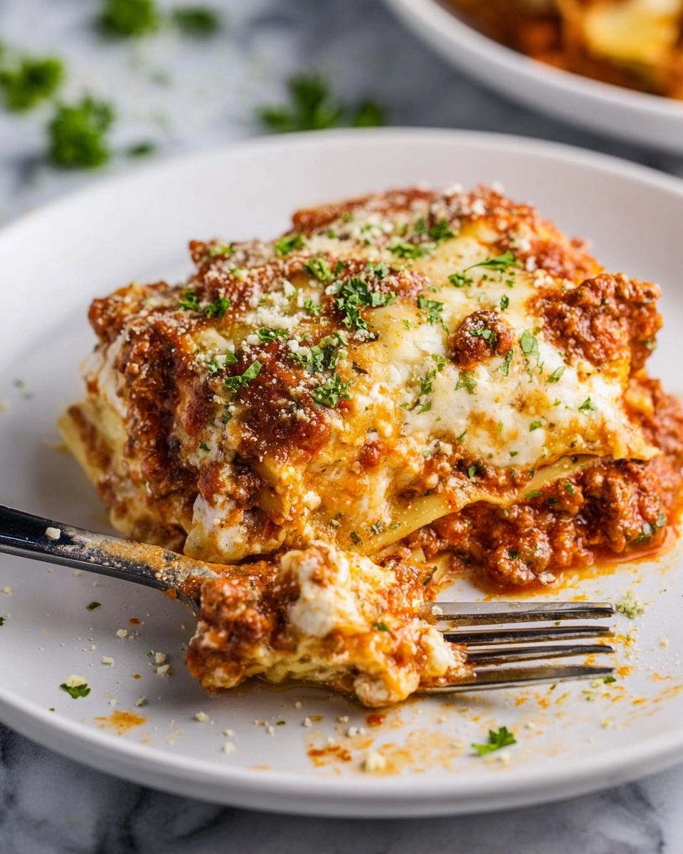 A white plate holds a serving of lasagna with about four visible layers, each alternating between creamy cheese layers in pale white and soft yellow tones and thick meaty sauce layers in rich brownish red. The top is covered with melted cheese in light golden brown and orange spots, sprinkled with small bits of grated cheese and green parsley leaves scattered around. The texture looks soft and slightly chunky from the sauce and melted cheese. A silver fork is placed under a piece of lasagna, lifting a bite that shows the layered pasta sheets and sauce. The background is a white marbled surface with hints of another dish and some green herbs scattered very lightly. Photo taken with an iphone --ar 4:5 --v 7