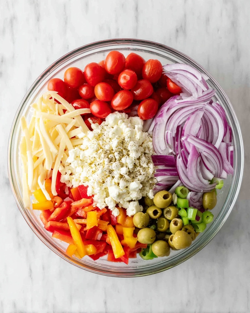 A clear glass bowl sits on a white marbled surface, holding seven distinct layers of fresh salad ingredients. At the top, there are bright red halved cherry tomatoes arranged next to thinly sliced red onions with light purple rings. In the middle, a big mound of crumbly white cheese covers part of the bowl, surrounded on one side by short, pale yellow cheese strips with a sprinkle of black pepper and salt beside them. At the bottom, vibrant chopped red and yellow bell peppers create a colorful layer next to a pile of green olives, some whole and some sliced. The ingredients are neatly separated, creating a vibrant and fresh look. Photo taken with an iphone --ar 4:5 --v 7