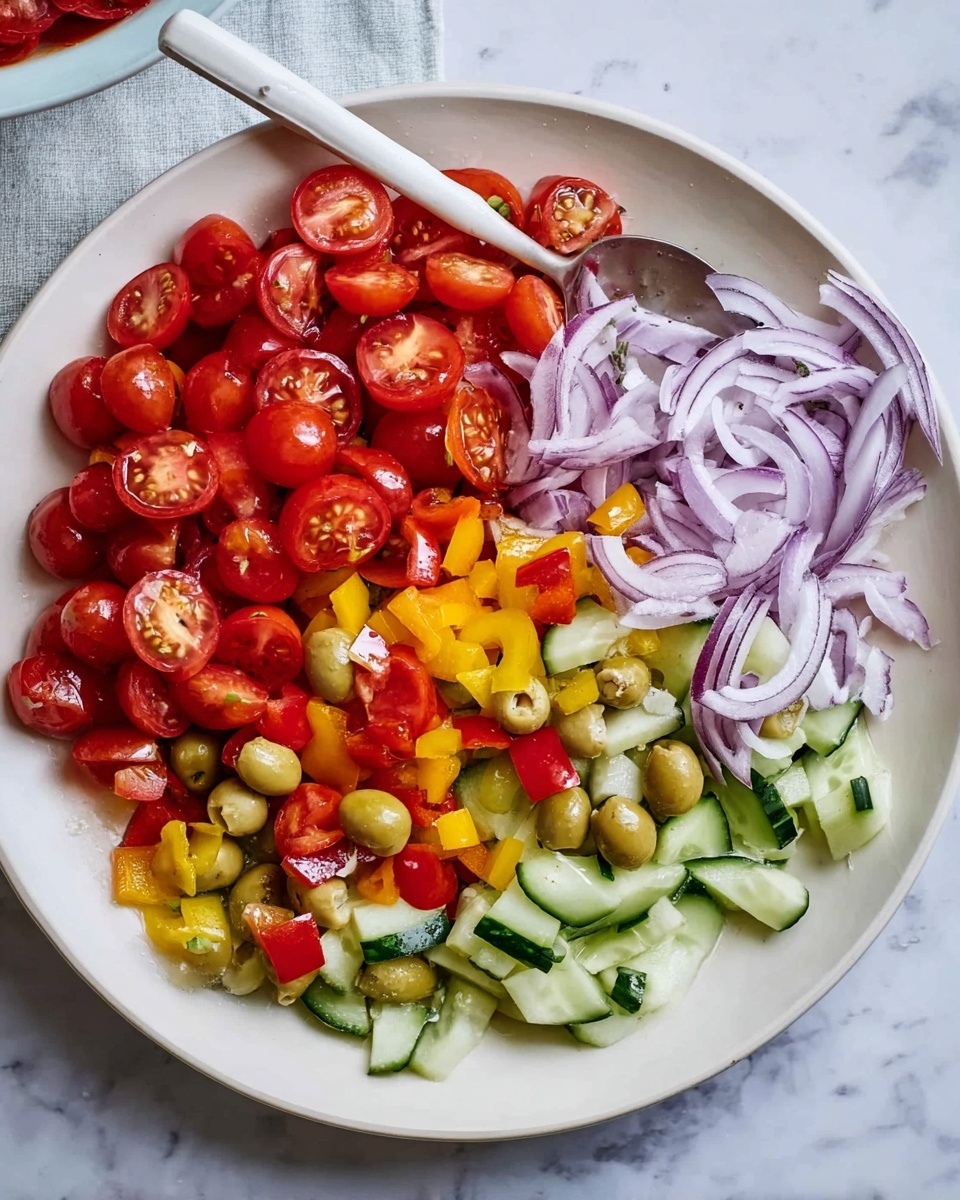 A white plate on a white marbled surface holds a colorful salad arranged in four distinct layers. At the bottom, there are thick slices of green cucumber mixed with whole and halved green olives. Above that, scattered diced yellow and red bell peppers add bright pops of color. On the right side, thinly sliced pale purple onion curves neatly layered, their texture soft and slightly translucent. At the top left, there is a generous pile of halved red cherry tomatoes, shiny and fresh. A white spoon is placed on the left side of the plate, resting among the vegetables. Photo taken with an iphone --ar 4:5 --v 7