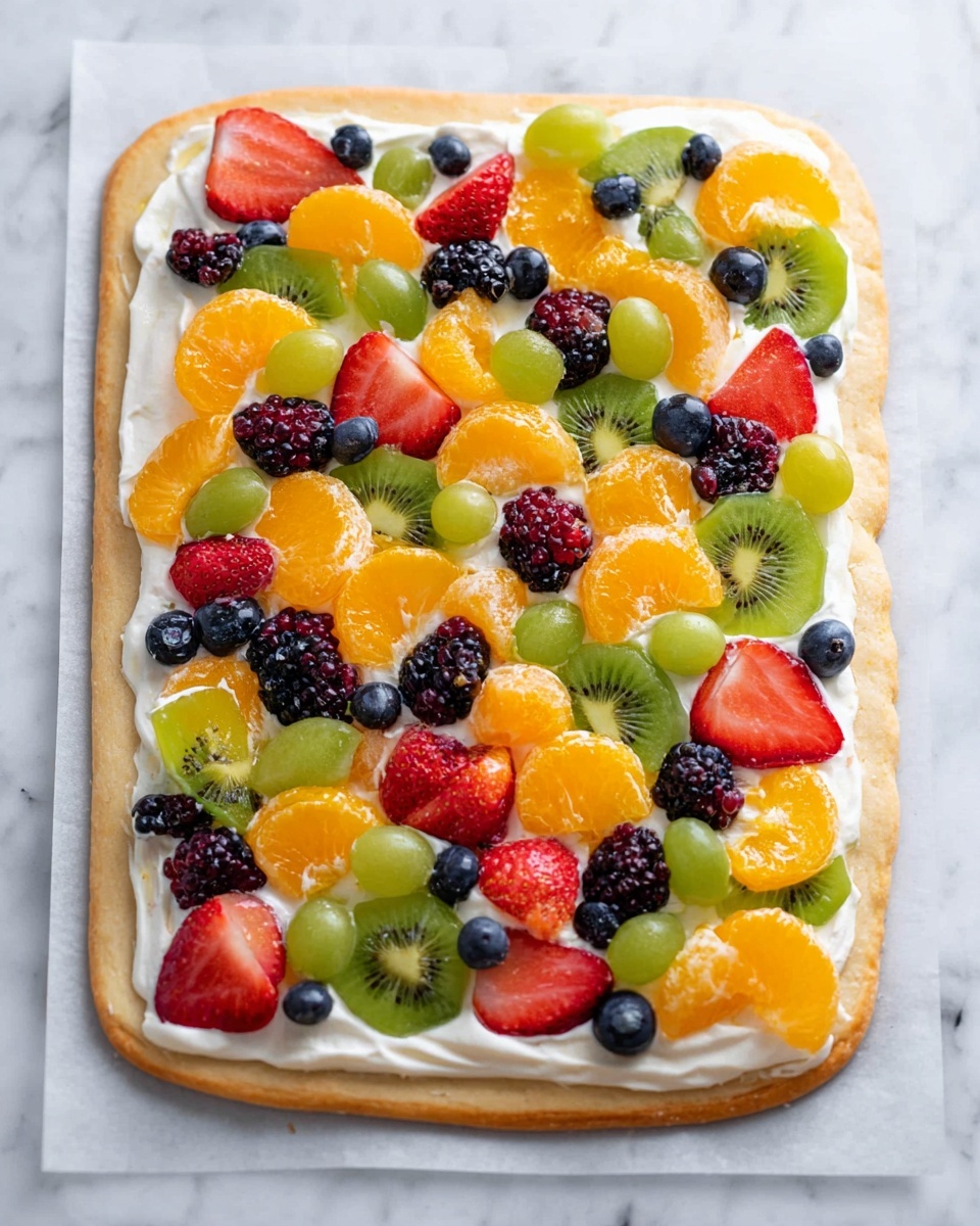 A large rectangular fruit pizza with a thick, light golden crust as the base layer, topped with a smooth white creamy spread as the second layer, and covered generously with many colorful fruit pieces as the third layer, including bright orange mandarin slices, green kiwi slices with small black seeds, whole green grapes, red strawberry halves, dark purple blackberries, and small blue blueberries, all arranged randomly on the white creamy spread, with the pizza placed on parchment paper over a white marbled surface photo taken with an iphone --ar 4:5 --v 7