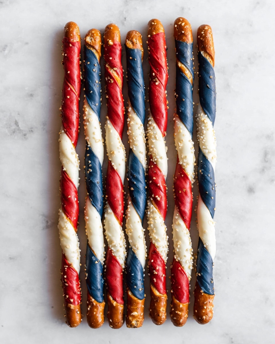 Six pretzel sticks are laid side by side on a white marbled surface. Each pretzel stick is layered with three colors of thick, twisted coatings: dark blue at the top, followed by a middle layer of red, and then a white layer near the bottom, leaving the plain brown pretzel tip with salt crystals visible. The coatings are uneven and textured, with some parts showing small gaps that reveal the pretzel beneath. The sticks are evenly spaced and aligned vertically. Photo taken with an iphone --ar 4:5 --v 7