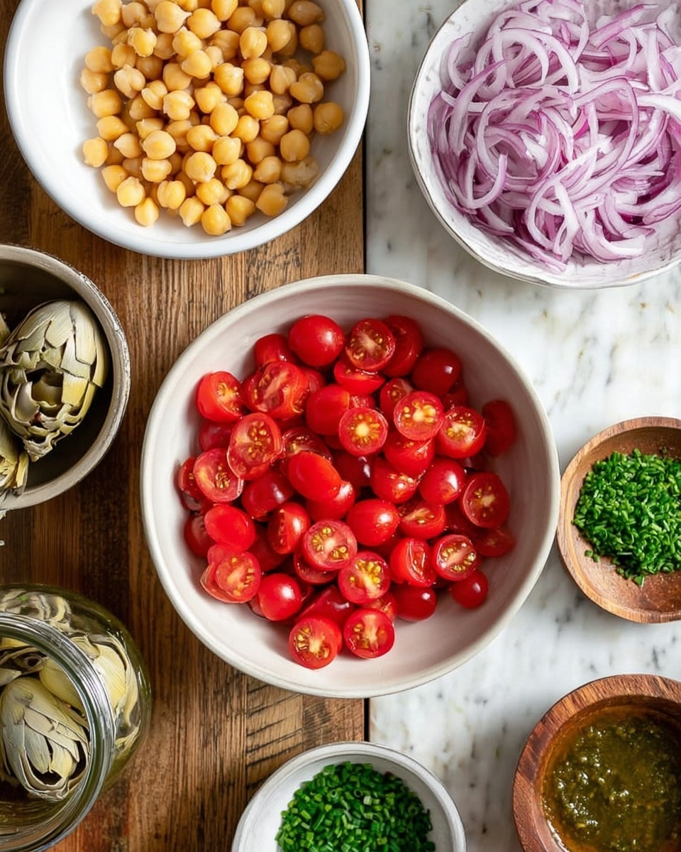 The image shows a top-down view of a white bowl filled with halved bright red cherry tomatoes in the center on a wooden surface. Surrounding it are smaller white bowls: one with pale yellow chickpeas, another with thinly sliced purple onions, and a third with green chopped herbs. There is also a small white bowl with green capers and a wooden bowl with finely chopped green chives. At the bottom, there is a glass jar filled with artichoke hearts and a jar with green herb dressing. The background is a white marbled texture and a woman's hand is not visible in the image. photo taken with an iphone --ar 4:5 --v 7