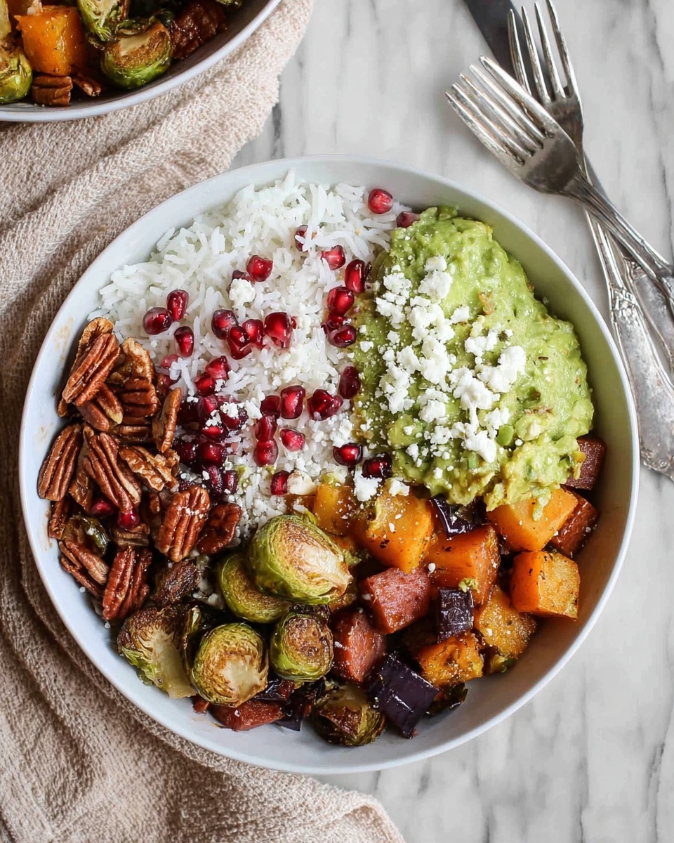 A white bowl filled with a layered dish starting with a base of white rice scattered on top. Roasted vegetable pieces, including golden-brown squash slices, small cubed orange pieces, and brussels sprouts, are spread over the rice. There are also dark roasted chunks adding contrast. On one side, there is a mound of bright green guacamole sprinkled with a few red pomegranate seeds. Light blue cheese crumbles and whole pecans sit over the vegetables, adding texture. A silver spoon rests inside the bowl on the right side. The bowl is placed on a dark wooden surface with a white marbled textured background. photo taken with an iphone --ar 4:5 --v 7