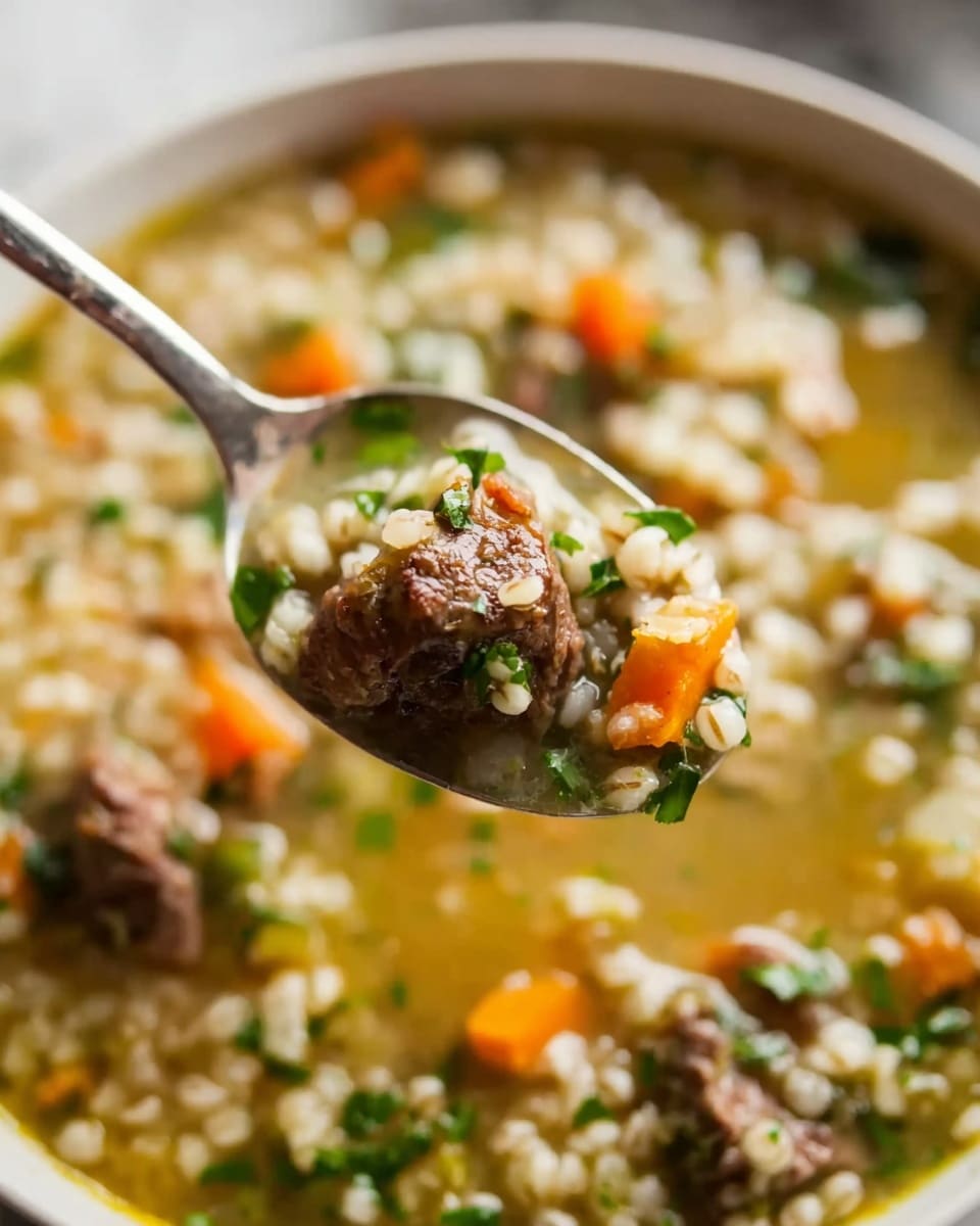 The image shows a close-up of a spoon lifting a portion of soup. The spoon holds a piece of browned meat, light beige grains, small orange carrot cubes, and green herbs sprinkled on top. The soup underneath has a light yellow broth with visible chunks of carrots, grains, and pieces of meat, all mixed together. The background shows more soup in a white bowl set on a white marbled surface. Photo taken with an iphone --ar 4:5 --v 7