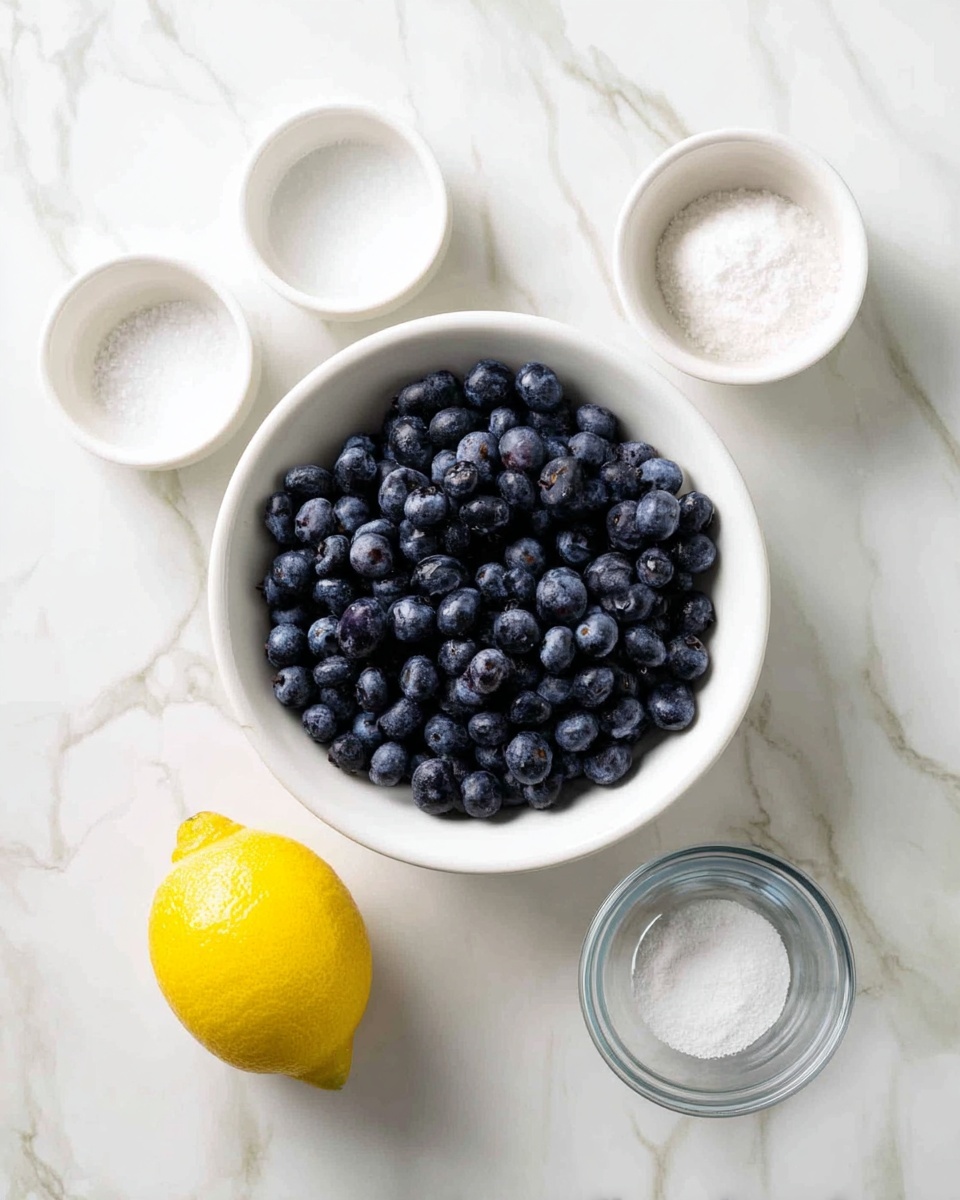 A top view of six ingredients on a white marbled surface, with a large white bowl in the center filled with many dark blue, round blueberries. Around the bowl are five smaller white bowls showing different ingredients: a whole bright yellow lemon on the bottom left, a small empty white bowl on the top left, a white bowl with white granulated sugar near the top center, a tiny white bowl with fine salt on the top right, and a small clear glass bowl with white powder on the bottom right. The scene is bright and clean, showing clear details of all ingredients photo taken with an iphone --ar 4:5 --v 7