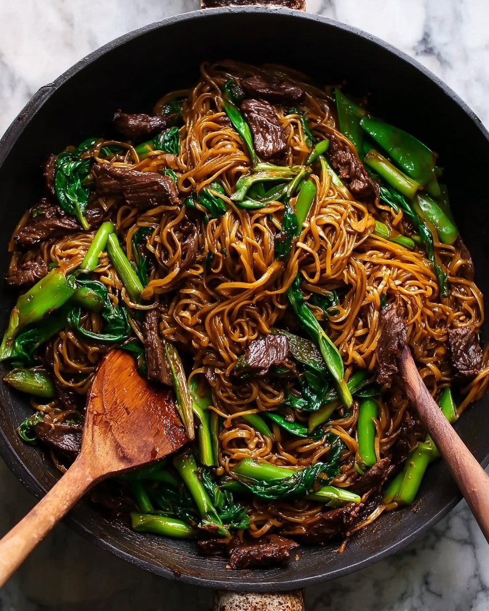 The image shows a white bowl filled with dark brown noodles mixed with pieces of cooked beef and bright green leafy vegetables on top. The noodles have a smooth, slightly shiny texture, and the beef looks tender with a slightly darker brown color. The green vegetables add a fresh contrast, scattered unevenly but mostly around the edges of the bowl. There is a pair of dark brown chopsticks resting inside the bowl, held by a woman's hand, positioned on the right side. In the background, there is another white bowl with the same dish, a cup filled with dark liquid, and all items are placed on a white marbled surface. photo taken with an iphone --ar 4:5 --v 7