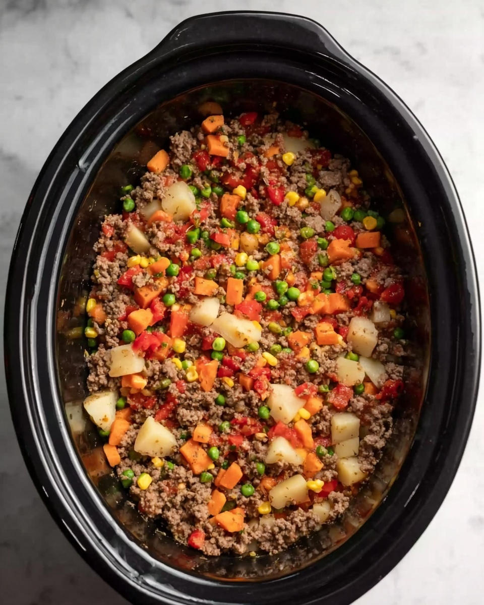 The image shows a slow cooker filled with a mixed dish consisting of several layers blended together. The base and main part is soft cooked ground meat with a brown color and crumbly texture, mixed evenly with small diced pieces of red tomatoes, orange carrots, yellow corn, green peas, and light tan potatoes. These ingredients are spread uniformly throughout the dish. The slow cooker is black, and the background is a white marbled surface. Photo taken with an iphone --ar 4:5 --v 7