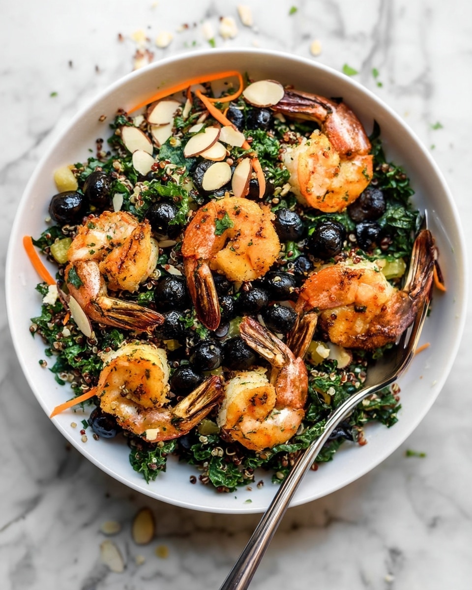 A white bowl filled with a layered salad starts with a base of dark green chopped kale mixed with light-colored quinoa. Scattered throughout are thin, bright orange carrot strips and small, sliced pale almond pieces. On top, there are several golden brown cooked shrimp with bits of herbs on them, arranged evenly around the bowl. The dark blueberries add pops of deep blue, contrasting with the greens and oranges. A metal spoon rests inside the bowl, angled towards the top left. The bowl sits on a white marbled surface with a few almond slices scattered around. photo taken with an iphone --ar 4:5 --v 7