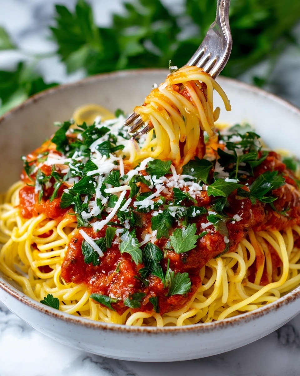 A close-up view of a bowl with three main layers: the bottom layer is yellow cooked spaghetti with a soft texture, the middle layer is bright red tomato sauce covering parts of the spaghetti, and the top layer is fresh dark green parsley leaves sprinkled all over with some white shredded cheese mixed in. A fork is lifting some spaghetti with sauce and parsley, positioned at the center of the bowl. The bowl is white with a slightly textured edge, placed on a white marbled surface with blurred green parsley in the background. Photo taken with an iphone --ar 4:5 --v 7