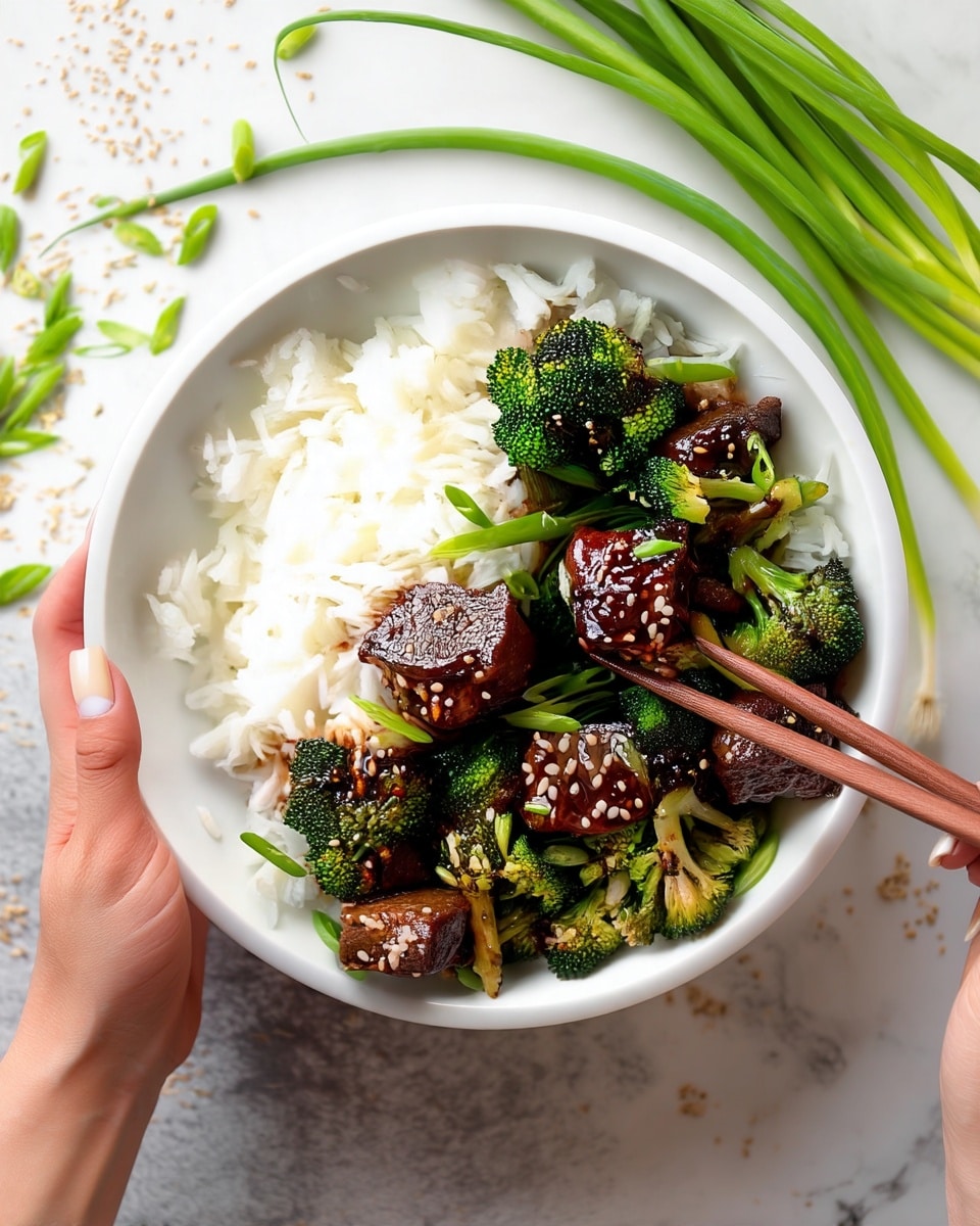 A white bowl filled with two main layers: on the left, a fluffy bed of white rice, and on the right, a colorful mix of green broccoli florets and glossy, dark brown meat cubes sprinkled with sesame seeds and chopped green onions. A woman's hand holds the bowl, while another woman's hand uses wooden chopsticks to pick up a piece of the meat and broccoli mix. The bowl is placed on a white marbled surface scattered with sesame seeds and green onion pieces, with some green onions visible in the background. photo taken with an iphone --ar 4:5 --v 7